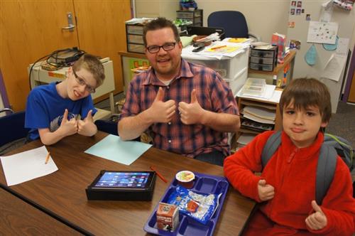 Staff member with two students